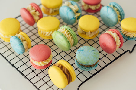 traditional french colorful macarons in a rows on a metal meshの写真素材