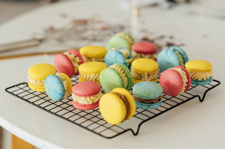 traditional french colorful macarons in a rows on a metal meshの写真素材