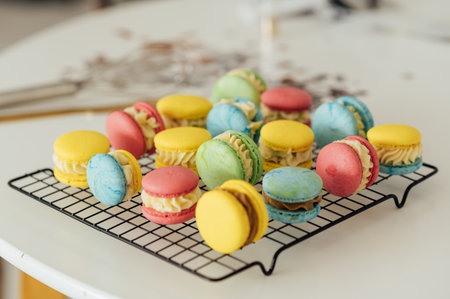 traditional french colorful macarons in a rows on a metal meshの写真素材