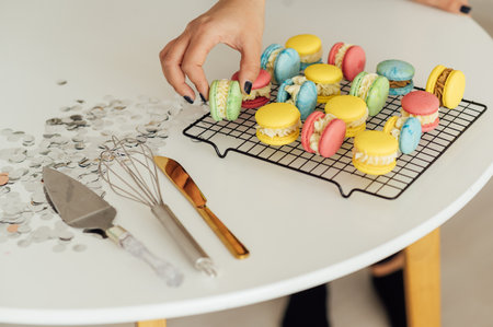 traditional french colorful macarons in a rows on a metal meshの写真素材