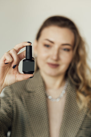 Woman nails master demonstrates new modern nail polishの写真素材