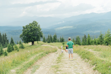 The Ukrainian boy goes up the mountain road forward. Motivating photoの写真素材