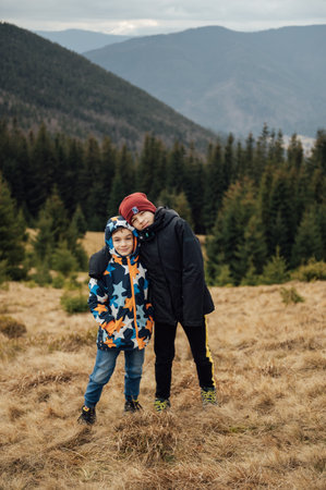 Two Brother boys stand at the top of the mountain. Ukrainian Carpathiansの写真素材