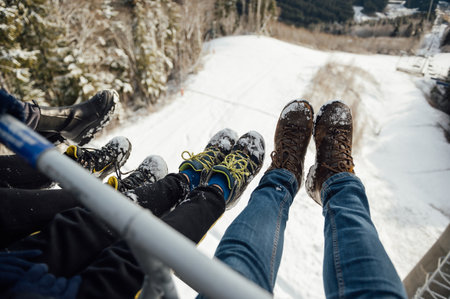 Feet in front of Chair lift during the rise to the topの写真素材