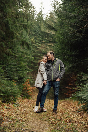 Loving young couple hugging together in nature on the background of mountains.の写真素材