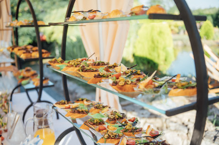 A large selection of food and different snacks in the oncoming zone of guests. A buffet for guestsの写真素材