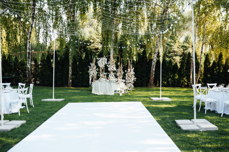Wedding table setting for newlyweds. Festive table decorated with white plates and napkins.の写真素材
