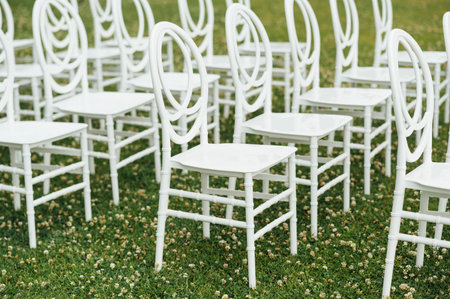 Chairs set up by the green lawn in preparation for a wedding reception