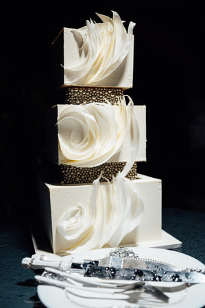 Premium square form wedding cake three floors at the evening ceremonyの写真素材