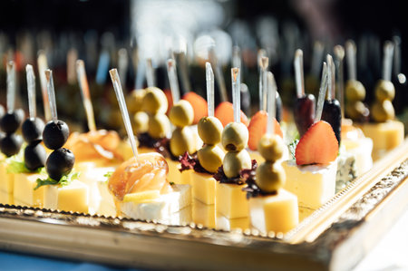The closeup image of the various small cup cakes on mirror plateの写真素材