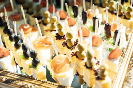 The closeup image of the various small cup cakes on mirror plateの写真素材