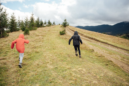 Two brothers are walking on mountains in Ukraineの写真素材