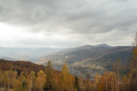 Golden autumn in the Carpathians. Mining arrays combined with trees with yellow leaves. Beautiful clouds and sunの写真素材
