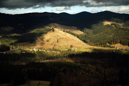 Golden autumn in the Carpathians. Mining arrays combined with trees with yellow leaves. Beautiful clouds and sunの写真素材