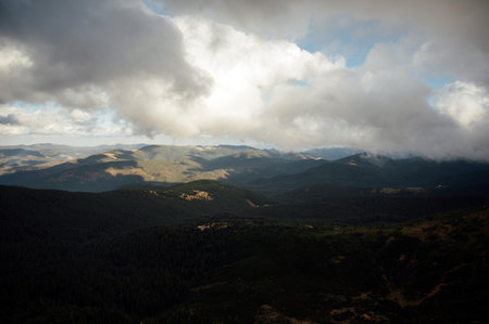 Golden autumn in the Carpathians. Mining arrays combined with trees with yellow leaves. Beautiful clouds and sunの写真素材
