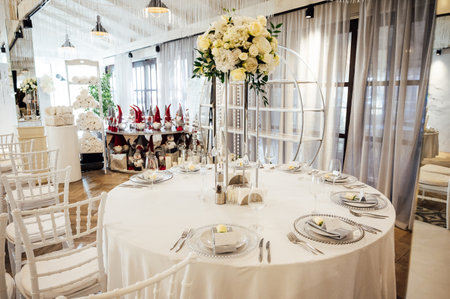 A beautiful vase of flowers on a table in a luxury restaurant. Wedding decorationsの写真素材