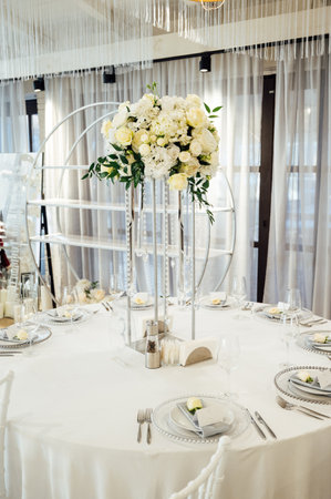 A beautiful vase of flowers on a table in a luxury restaurant. Wedding decorationsの写真素材