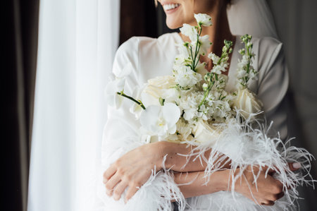 Boudoir photo of a beautiful girl with long hair. Flowers in the hands of a beautiful woman.の写真素材