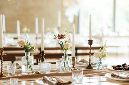 Elegant neutral coloured wedding table scape with flowers and candlesの写真素材