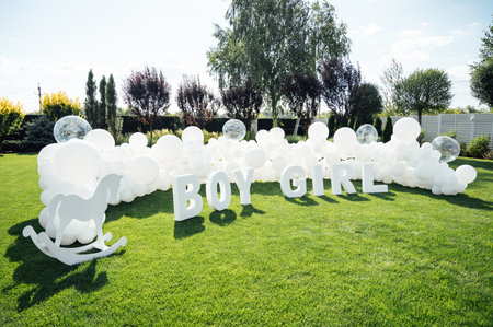 Large-scale photo zone made of white balloons and large letters at a gender party.の写真素材