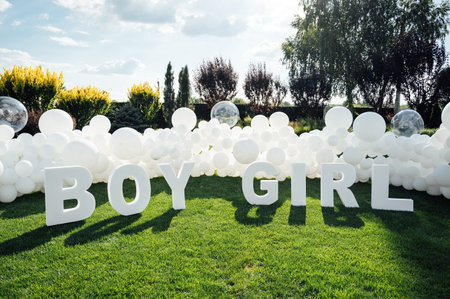 Large-scale photo zone made of white balloons and large letters at a gender party.の写真素材