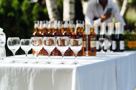 A lot of empty wine glasses. Row of clean glass transparent glasses are on a table on banquet in a barの写真素材