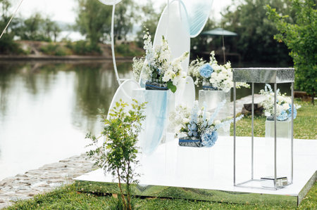 Place for wedding ceremony on river beach outdoors. Large installation of round archの写真素材