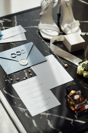 Wedding invitations. Wedding details of the bride. Bridal bouquet and other accessories. Shoes of the brideの写真素材