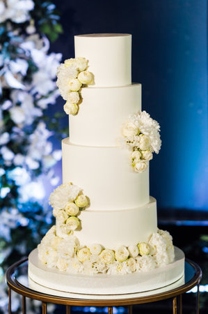 a beautiful wedding cake near the wedding arch in the eveningの写真素材