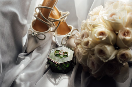 The brides wedding accessory in the form of a bouquet, wedding gold rings and shoes.の写真素材