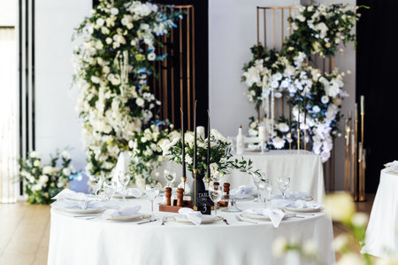 Luxurious restaurant. Luxurious interior, white tables, serving dishes and glasses for guestsの写真素材
