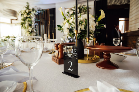 Luxurious restaurant. Luxurious interior, white tables, serving dishes and glasses for guestsの写真素材
