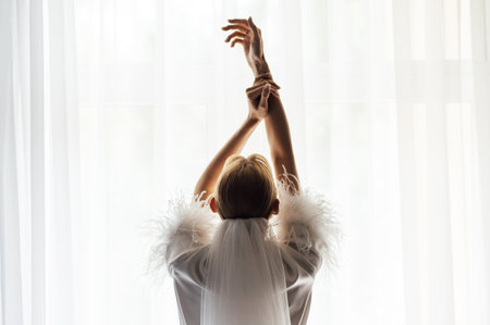 A tender bride strokes her body with her hands and sensually touches her skin. Sensual momentの写真素材