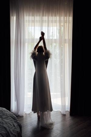 A tender bride strokes her body with her hands and sensually touches her skin. Sensual momentの写真素材