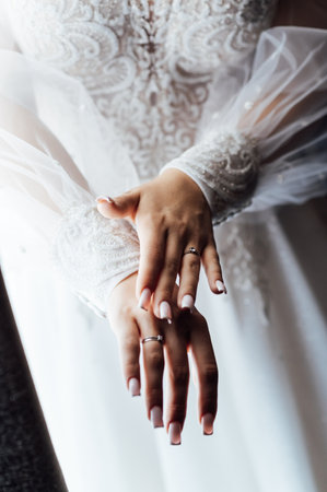 A tender bride strokes her body with her hands and sensually touches her skin. Sensual momentの写真素材