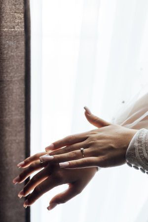 A tender bride strokes her body with her hands and sensually touches her skin. Sensual momentの写真素材