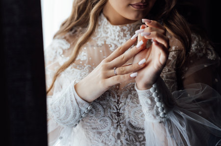 A tender bride strokes her body with her hands and sensually touches her skin. Sensual momentの写真素材