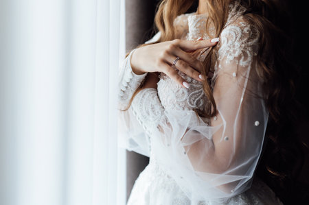 A tender bride strokes her body with her hands and sensually touches her skin. Sensual momentの写真素材