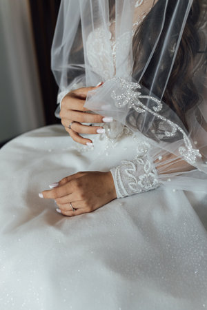 A tender bride strokes her body with her hands and sensually touches her skin. Sensual momentの写真素材