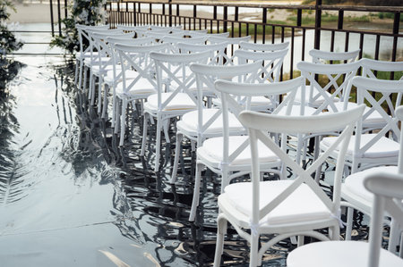 A wedding arch, decorated with flowers, stands on a podium, stands in the open airの写真素材