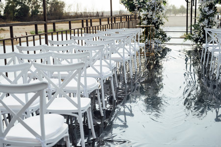 A wedding arch, decorated with flowers, stands on a podium, stands in the open airの写真素材