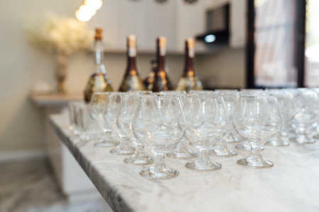 A lot of empty wine glasses. Row of clean glass transparent glasses are on a table on banquet in a barの写真素材