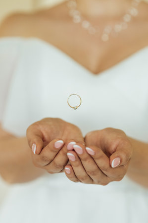 The bride in her wedding dress threw the ring in her hands. In the photo it looks like levitationの写真素材
