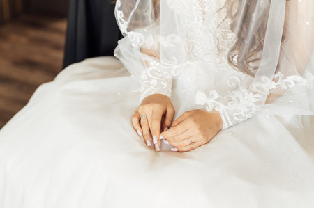 A tender bride strokes her body with her hands. Sensual momentの写真素材