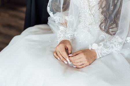 A tender bride strokes her body with her hands. Sensual momentの写真素材