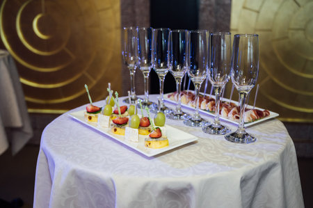 Appetizer Plate. An area for welcoming guests with food and empty champagne glassesの写真素材