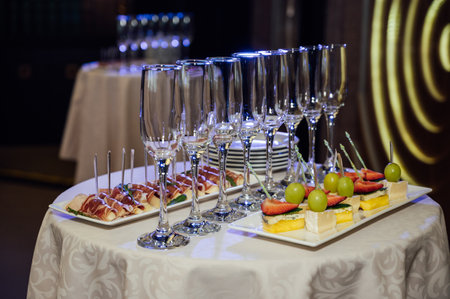 Appetizer Plate. An area for welcoming guests with food and empty champagne glassesの写真素材