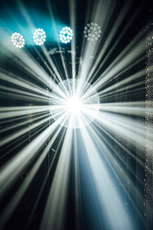 A mirrored disco ball reflects light rays throughout the room. Smoke enhances the visibilityの写真素材