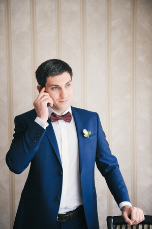 man  calls by telephone leaning other hand about a chair Valentines Dayの写真素材