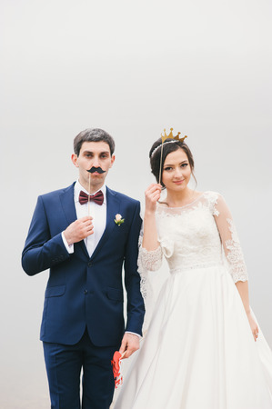 groom attached to the face paper mustaches and bride put to her  head a crown  Valentines Dayの写真素材